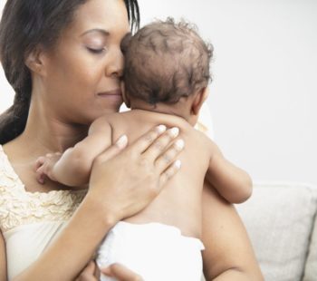Mother holding her sleeping daughter