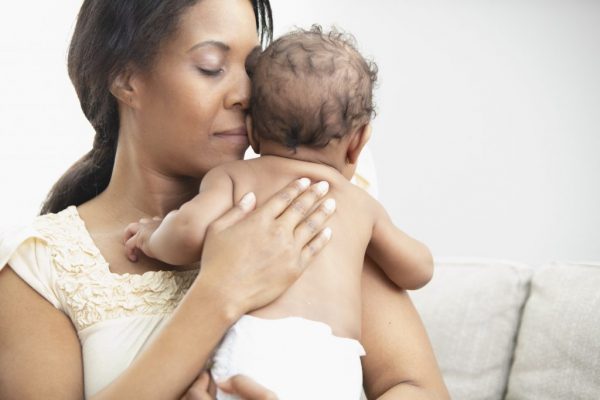 Mother holding her sleeping daughter